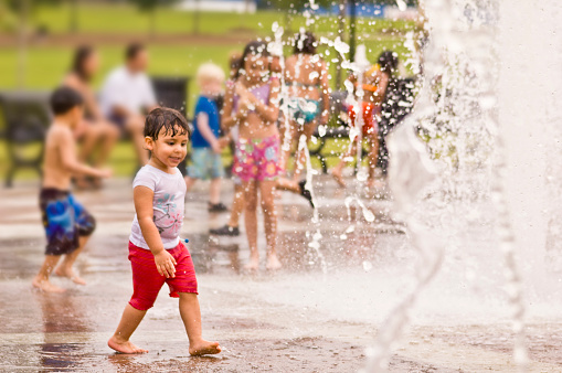 Kids playing in the Sugar Hill park fountain.