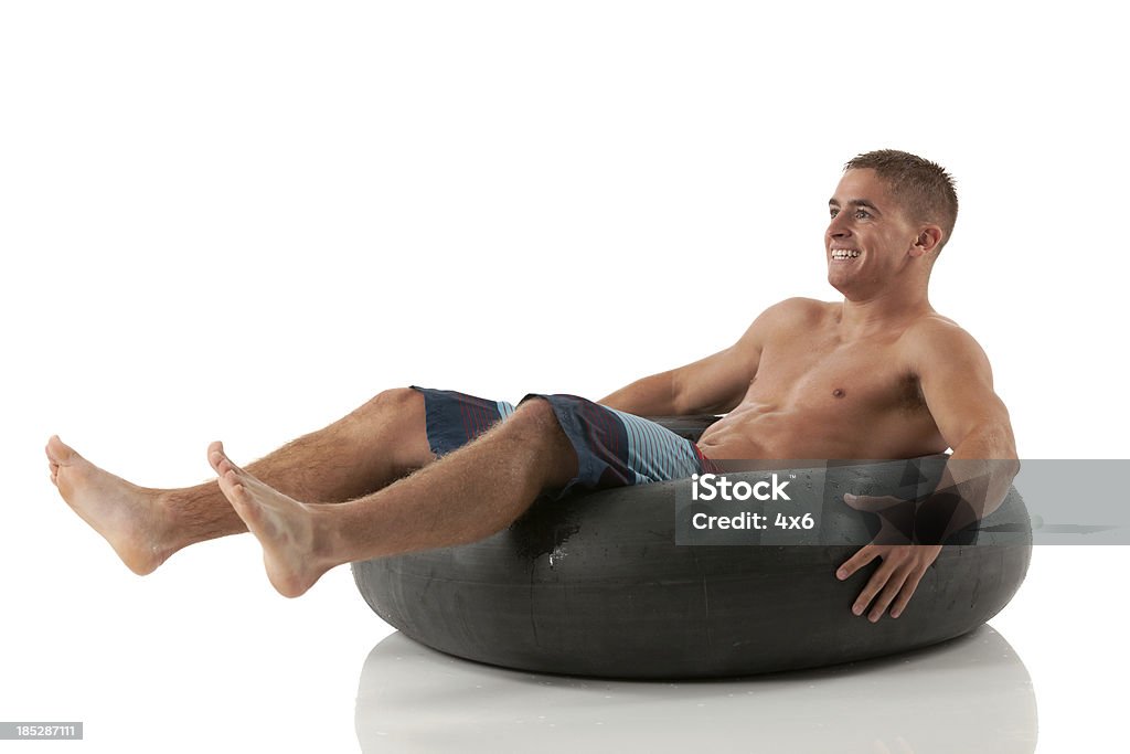 Homem deitado em uma boia - Foto de stock de Boia - Inflável royalty-free