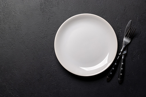 Mockup for a delicious meal. Empty plate on a table. Flat lay with copy space