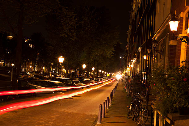 istock Amsterdam street at night with car light trails 185287339