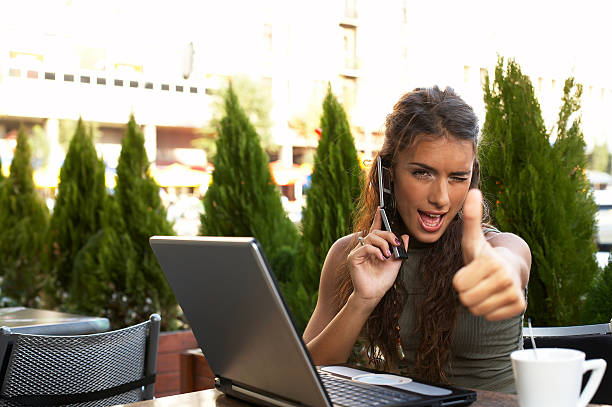 istock Woman with Laptop and Cellphone in cafe 185287654