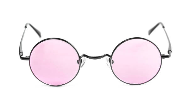 Rose Coloured Glasses A pleasant pair of pink spectacles lend a rosey sheen to life's dreary monotony.  Round tinted pink glasses are isolated on white. tinted sunglasses stock pictures, royalty-free photos & images