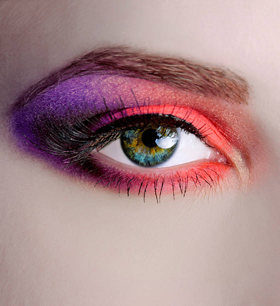 eye make-up macro woman with eye make-up macro shoot ; purple and orange colors. hazel blue eyes stock pictures, royalty-free photos & images