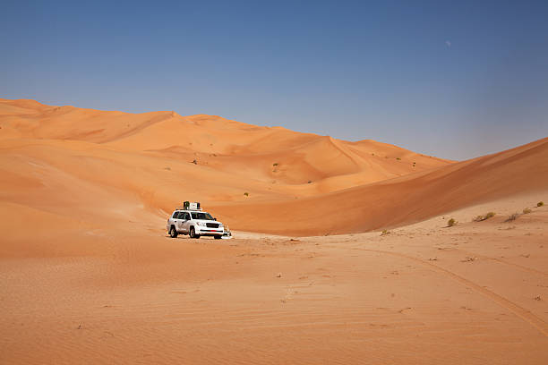 istock Car driving in the desert between sand dunes 185288536