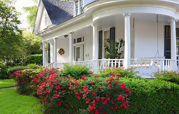 Southern Home with porch Southern Alabama home with beautiful porch and lovely red roses. southern usa stock pictures, royalty-free photos & images