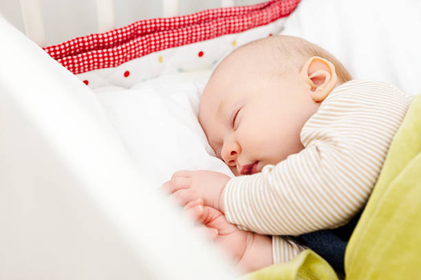 istock Cute baby sleeping in bed 185288592