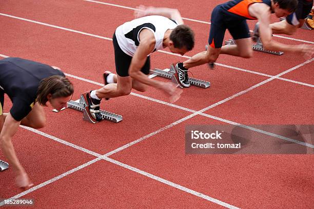 Sprinters In Starting Blocks Stock Photo - Download Image Now - Sprinting, Starting Line, Track Starting Block