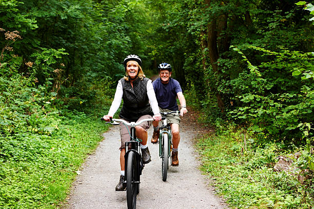 istock Active seniors riding bicycle in countryside 185289251