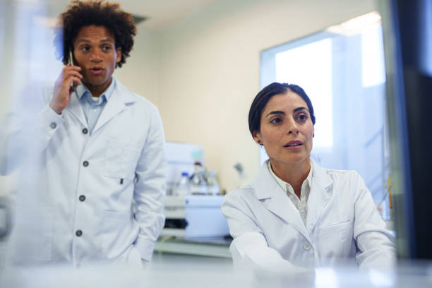 istock Mid-shot of two young scientists evaluating project results inside research facility 1852895601