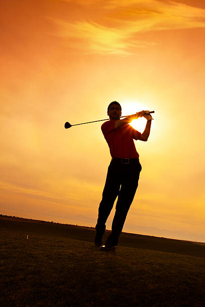 istock Golfer swinging at sunset 185289789