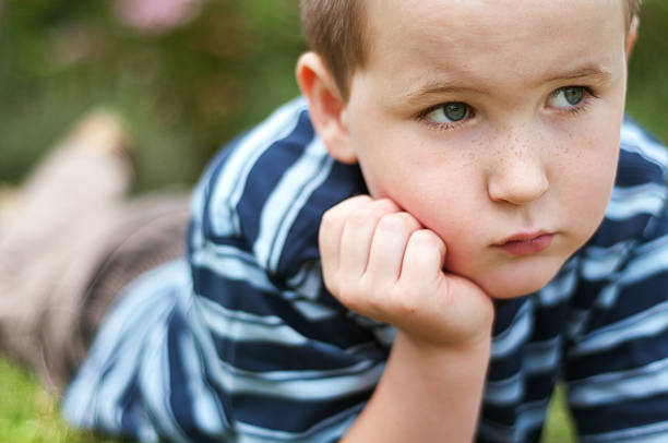 istock Cute little boy in the grass 185290021