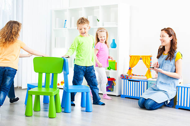 istock Preschool: Preschoolers Playing Musical Chairs. 185290438