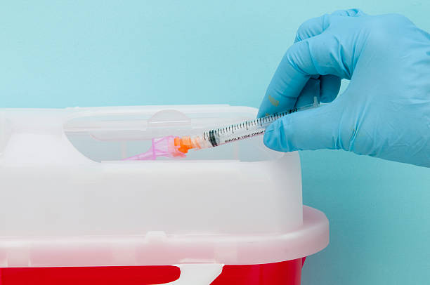 Safe needle and syringe disposal/close-up and isolated stock photo