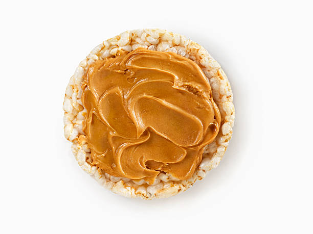 Rice Cake with Peanut Butter Rice Cake with Peanut Butter with Natural Drop Shadow- Photographed on Hasselblad H3D2-39mb Camera rice cake peanut butter stock pictures, royalty-free photos & images