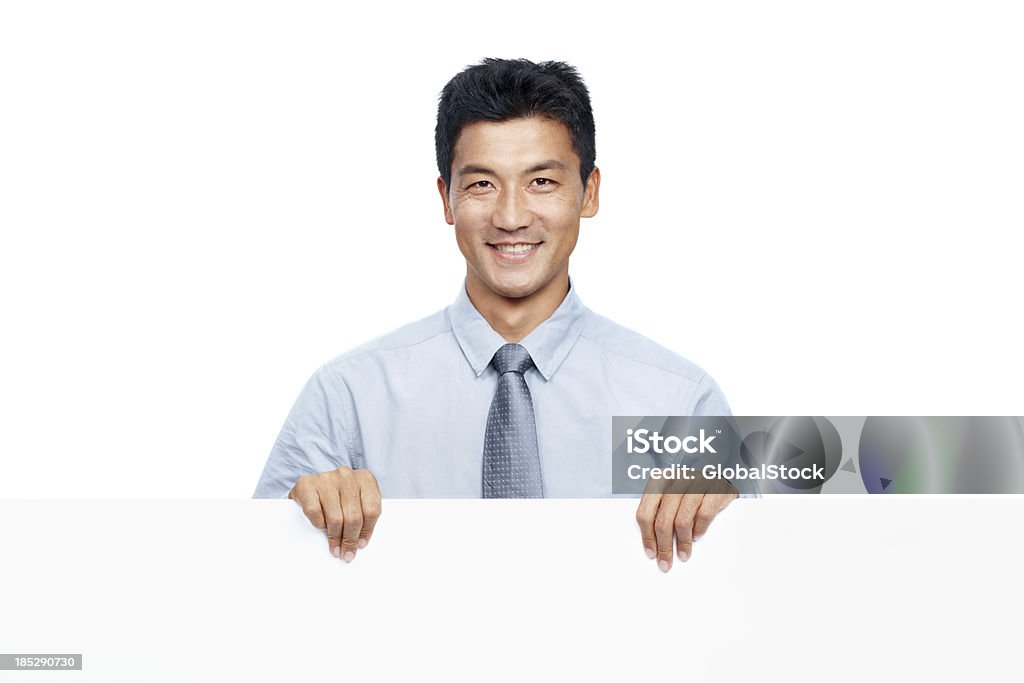 Making a positive presentation Isolated smiling businessman standing behind a white board resting two hands on it - copyspace Adult Stock Photo