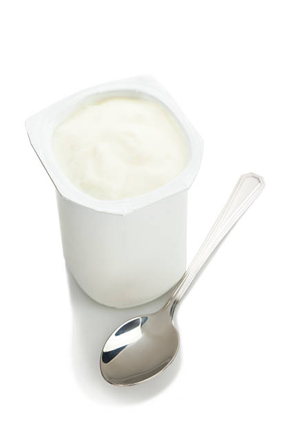 yogurt - spoon plastic isolated white foto e immagini stock