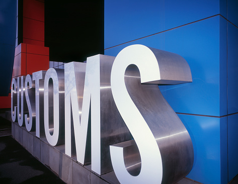 Large customs sign in front of modern colorful building. High-end scan of 6x7 cm transparency.