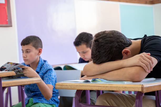 istock Student putting his head on the desk ,looks not feeling well or sleeping 1852912045