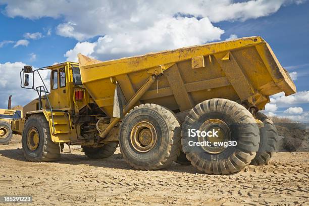Dump Truck In A New Road Construction Stock Photo - Download Image Now - Cloudscape, Commercial Land Vehicle, Construction Equipment