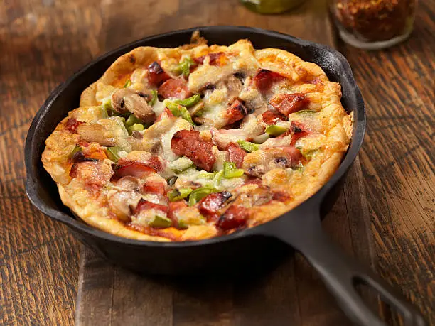 "Deep Dish Skillet Pizza with Sausage, Mushrooms and Green Peppers- Photographed on a Hasselblad H3D11-39 megapixel Camera System"