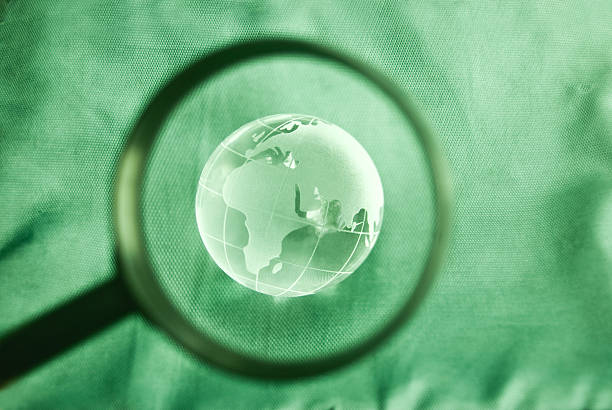 World globe with magnifying glass on blue background. 3d illustration