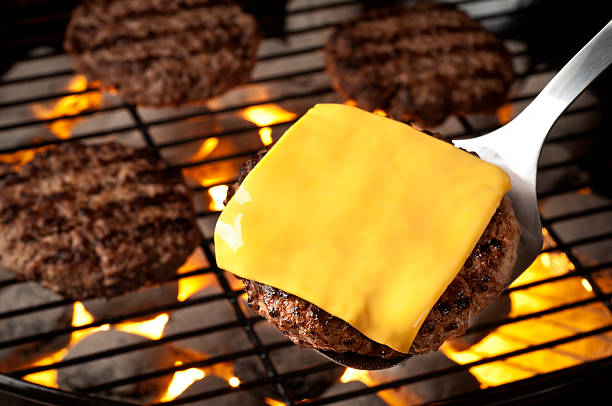 Grilled Burgers Grilled burgers on the grill.  Please see my portfolio for other food related images.  cheddar cheese photos stock pictures, royalty-free photos & images