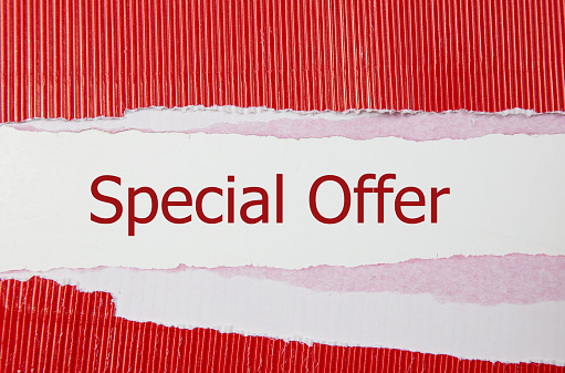 The text special offer appearing behind red torn paper