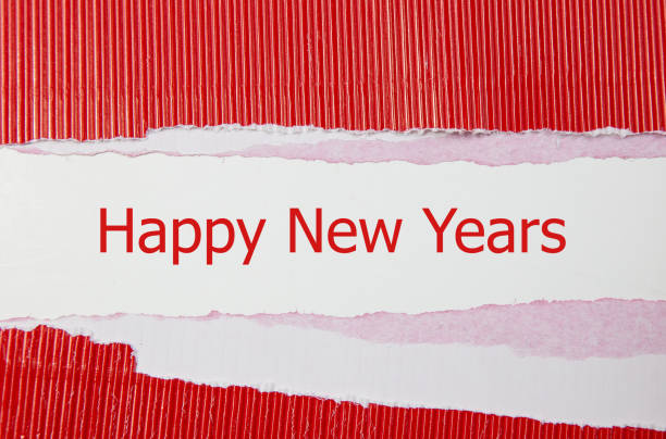 Words happy new years and red torn paper