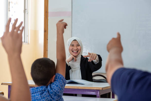 istock Students raising their hands to answer the teacher question 1852922489