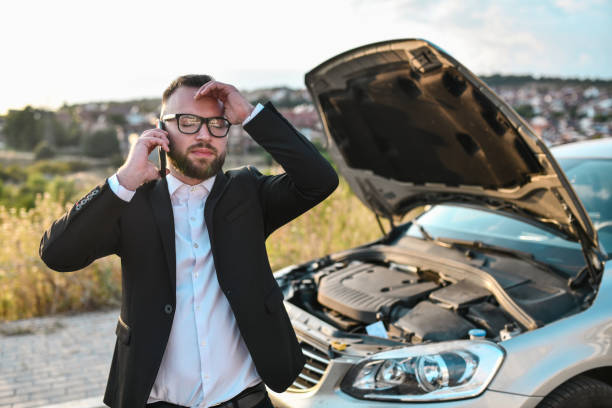 istock Stressed Businessman Calling Tow Service For Car 1852932268