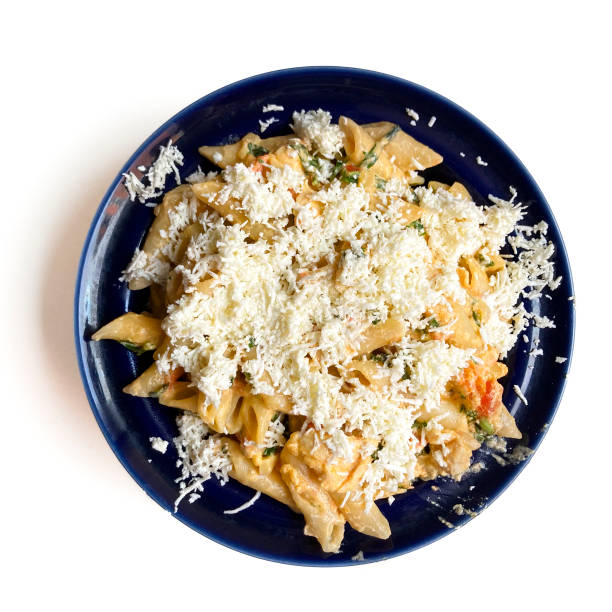 High angle view of pasta with chicken breast made at home for lunch with Parmesan cheese.