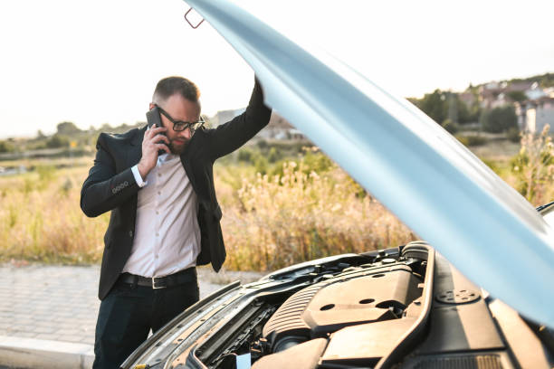 istock Businessman Calling Mechanic Via Smartphone For Tips During Car Problems On The Road 1852947511