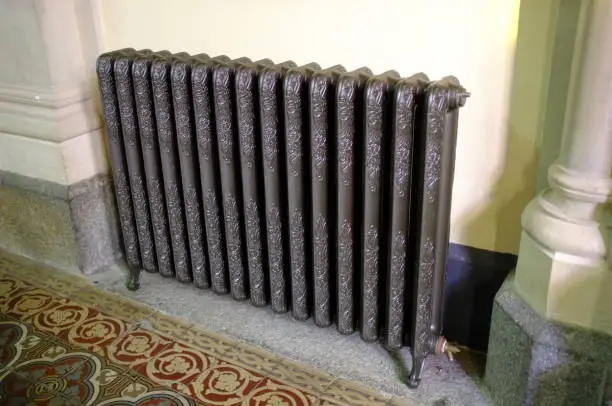 Wide angle image of cast iron radiator.