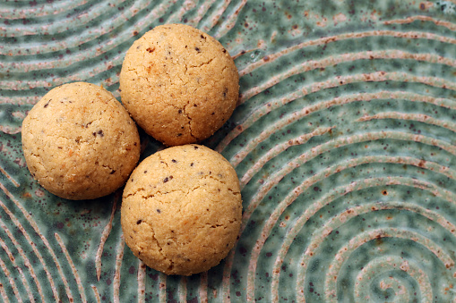 White Chocolate Caramel soft and macadamia nuts baked cookies served with cup of milk on the table close-up. Horizontal