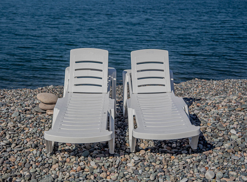 Sun loungers on the shore, vacation on the  Sea