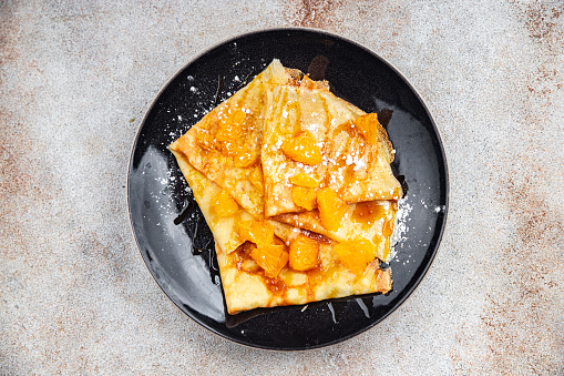 crepe pancake orange and syrup fresh delicious healthy eating cooking appetizer meal food snack on the table copy space food background rustic top view