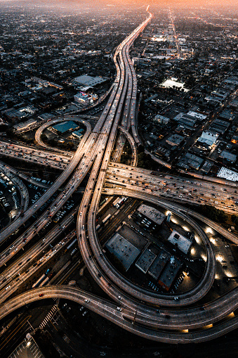 Helicopter point of view of Los Angeles highway interchanges at golden hour.