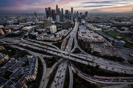 Helicopter point of view of Los Angeles highway interchanges at golden hour.