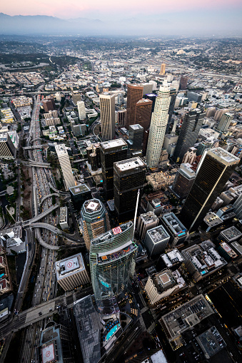 The view from above of Los Angeles Downtown and its skyscrapers during twilight captured from a helicopter.