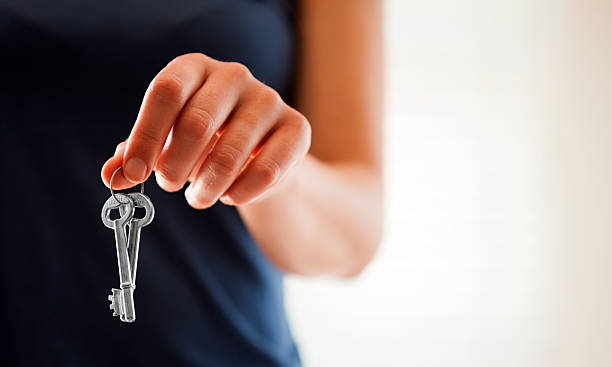 Keys Woman holding a set of keys. key lock stock pictures, royalty-free photos & images