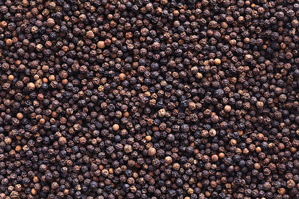 Full image of peppercorns as a background Black peppercorns fill the frame black peppercorn photos stock pictures, royalty-free photos & images