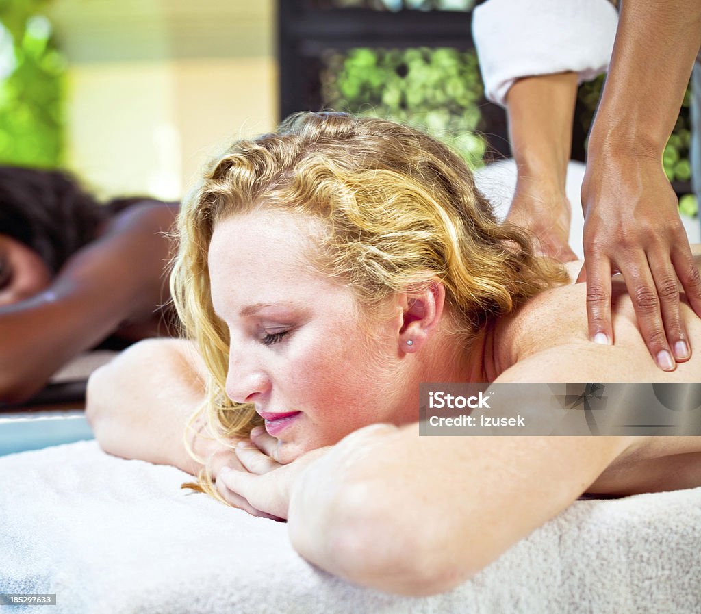 Back massage Young women getting back massage at spa. 20-24 Years Stock Photo