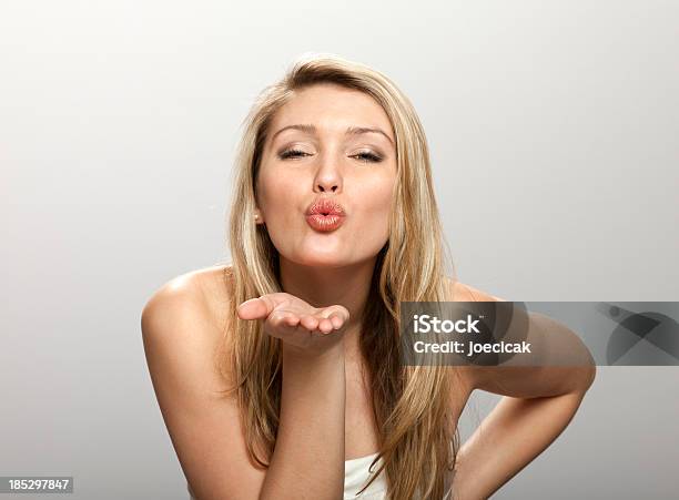 Blonde Woman Blowing Kisses To Someone Stock Photo - Download Image Now - Blowing a Kiss, Women, Kissing