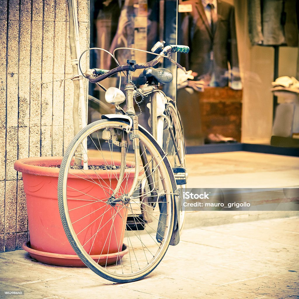 Bicycle Leaning Against Wall on Italian Street Old bicycle Leaning Against Wall on Italian Street. 1950-1959 Stock Photo