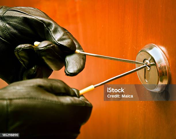 Thief Opening A Lock With Picklock Stock Photo - Download Image Now - Burglar, Door, Locksmith