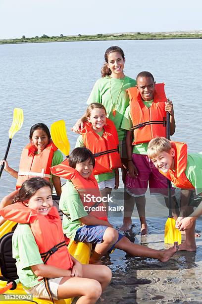 Estate Animatore Estivo E Bambini Con Kayak - Fotografie stock e altre immagini di Campo estivo - Campo estivo, Bambino, Composizione verticale