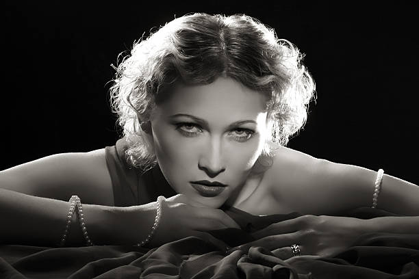 Film Noir Style.Diva with necklace Emulation of vintage style photography.Filters added for more effect. film noir style photos stock pictures, royalty-free photos & images