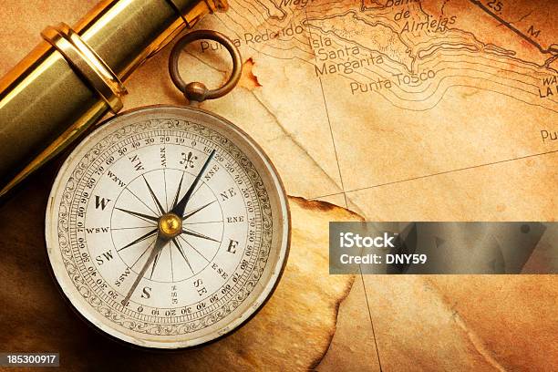 Compass And Spyglass On A Map Stock Photo - Download Image Now - Navigational Compass, Map, Antique