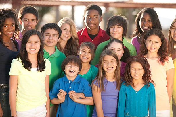 Smiling group of diverse children Diverse group of children outside. human age child multi ethnic group group of people stock pictures, royalty-free photos & images