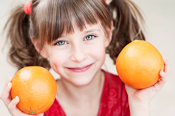 istock Little girl with oranges 185302942